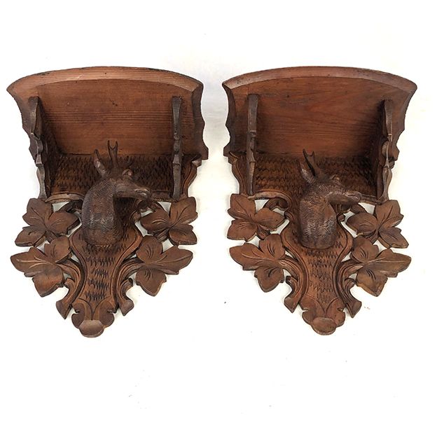 Pair of carved wooden wall consoles decorated with a deer's head