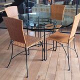 Glass and metal table and its 4 wicker chairs and glass Roche Bobois