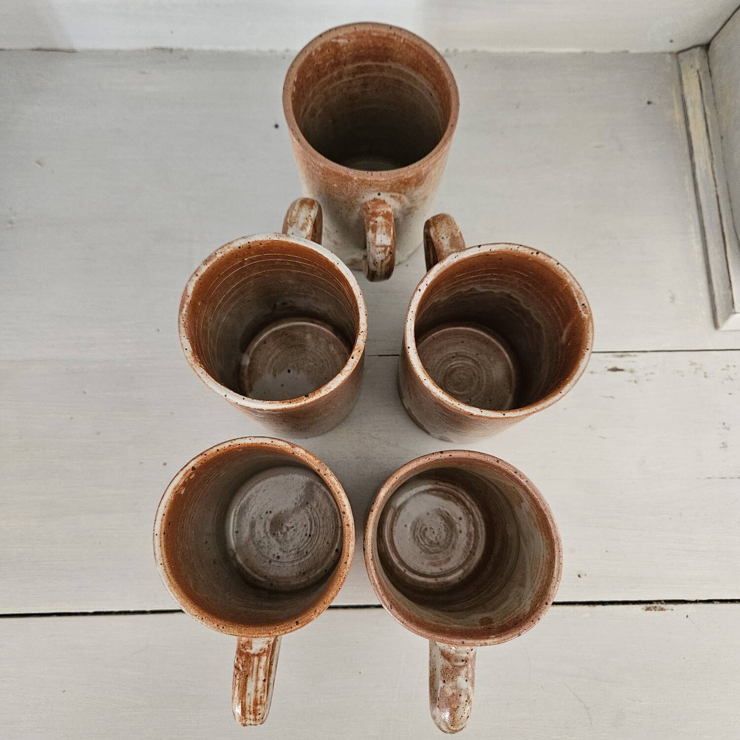 Set of 5 vintage handcrafted stoneware mugs in beige, pink, and white glazed stoneware