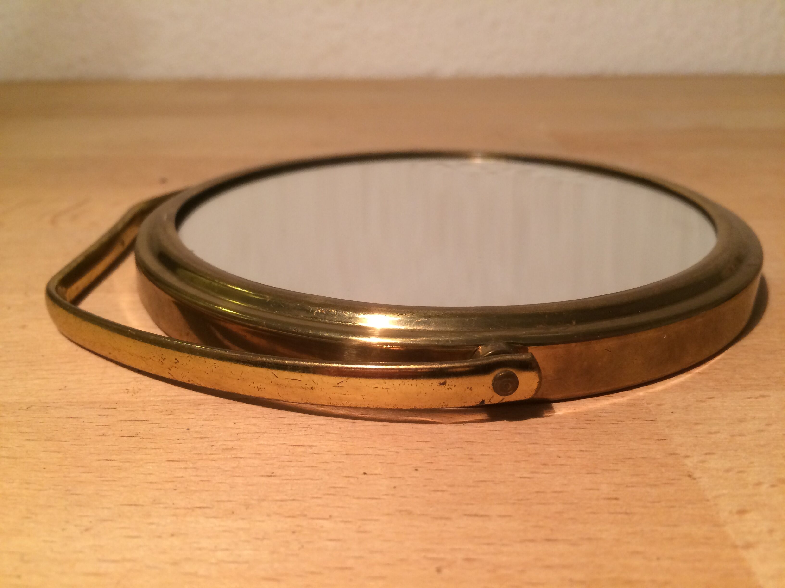 Vintage magnifiing gold round barber mirror