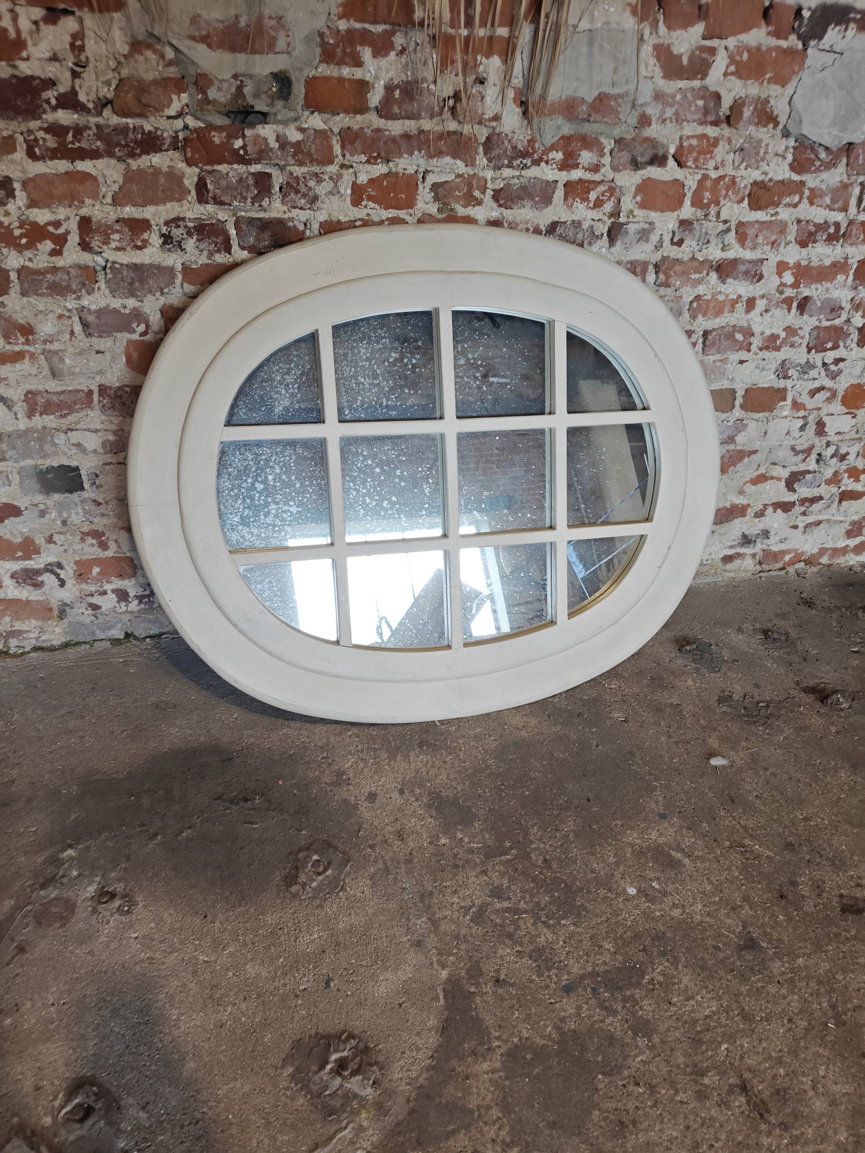 Oval mirror in window style with wooden crossbars – chic country decor