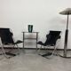 Bauhaus side table with a black glass top