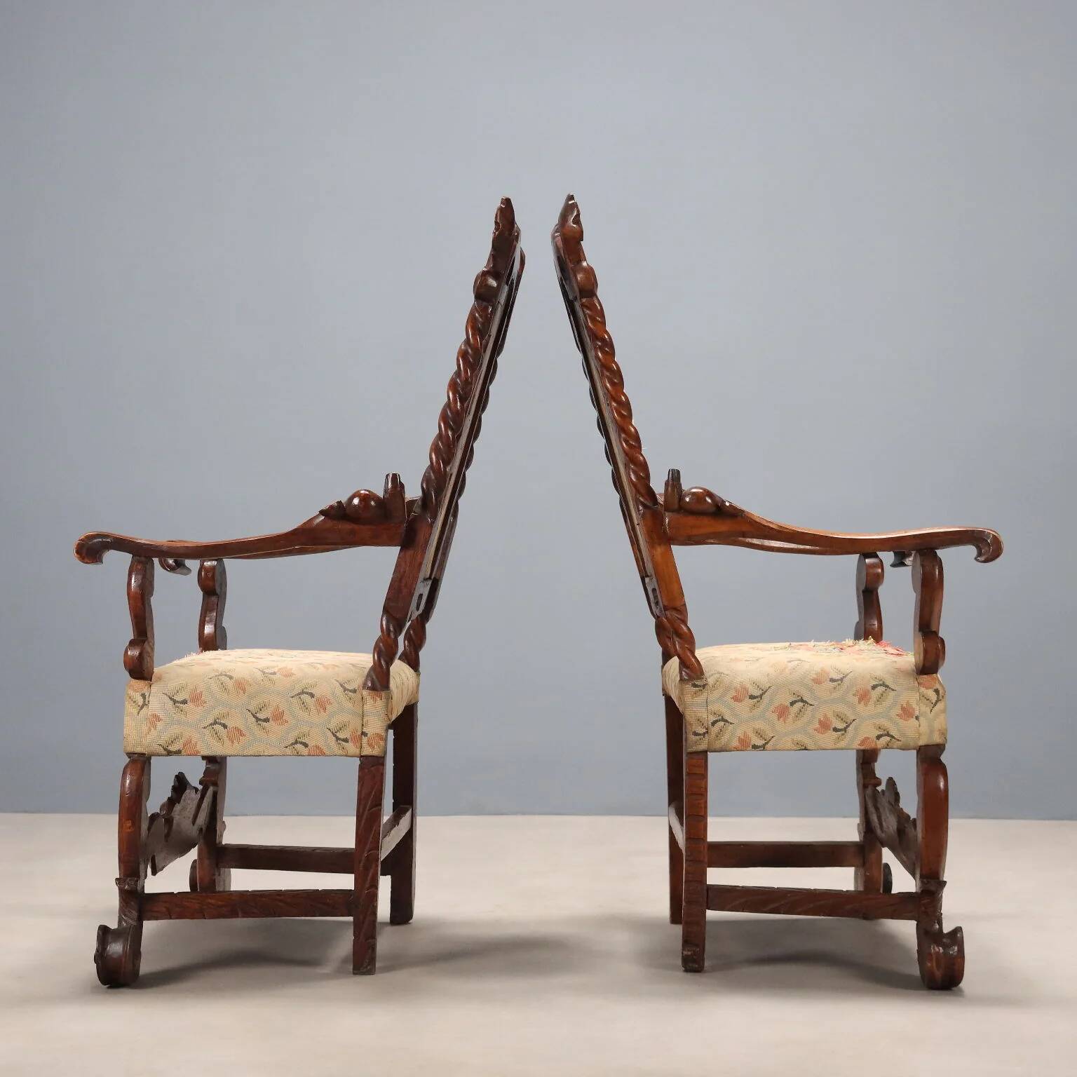Pair of antique Baroque armchairs in walnut and fabric, Italy, 17th century.