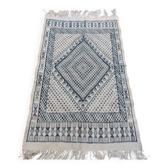 White and blue handwoven rug in natural wool