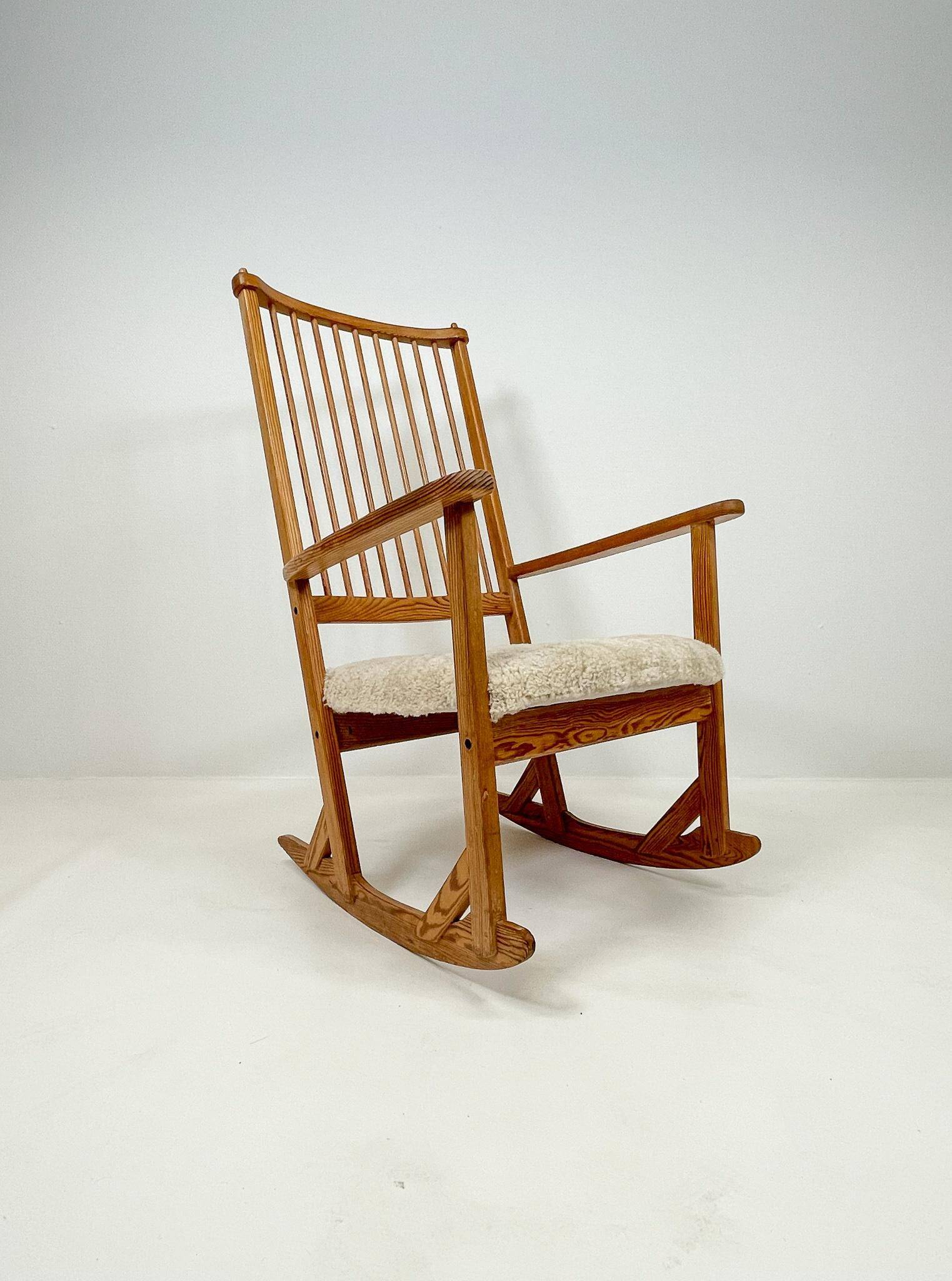 Mid-century rocking chair in pine and sheepskin by Yngve Ekström, Sweden.