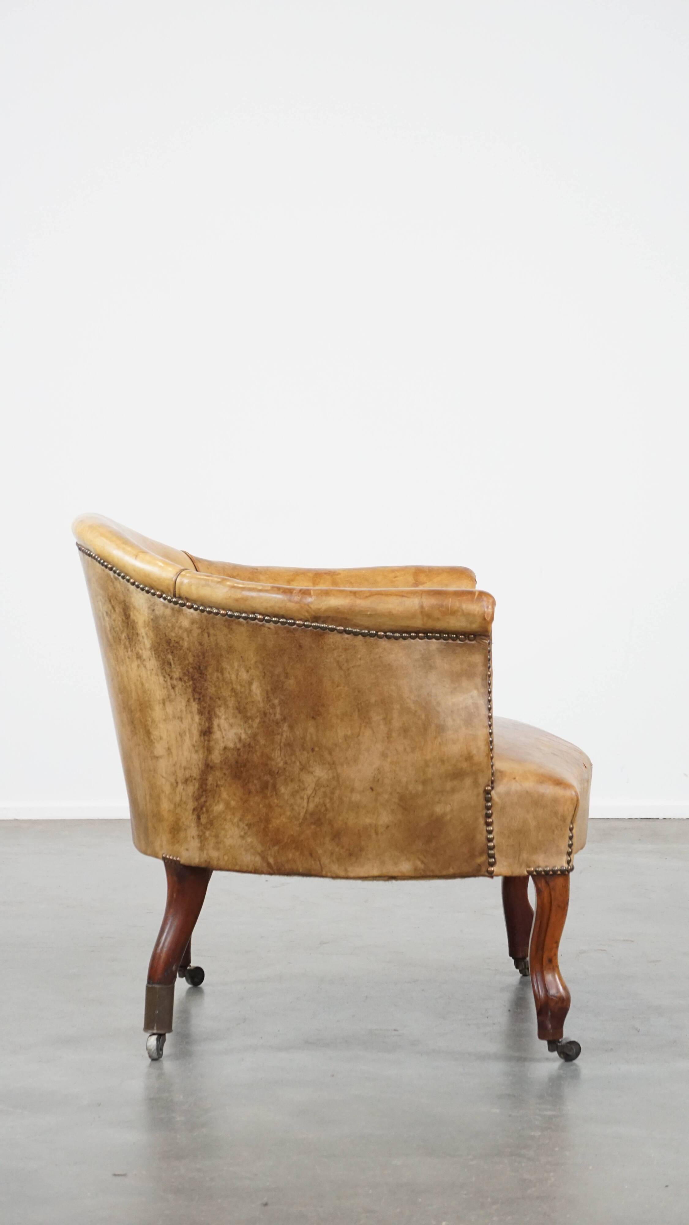 Antique sheep leather club chair/armchair on wheels