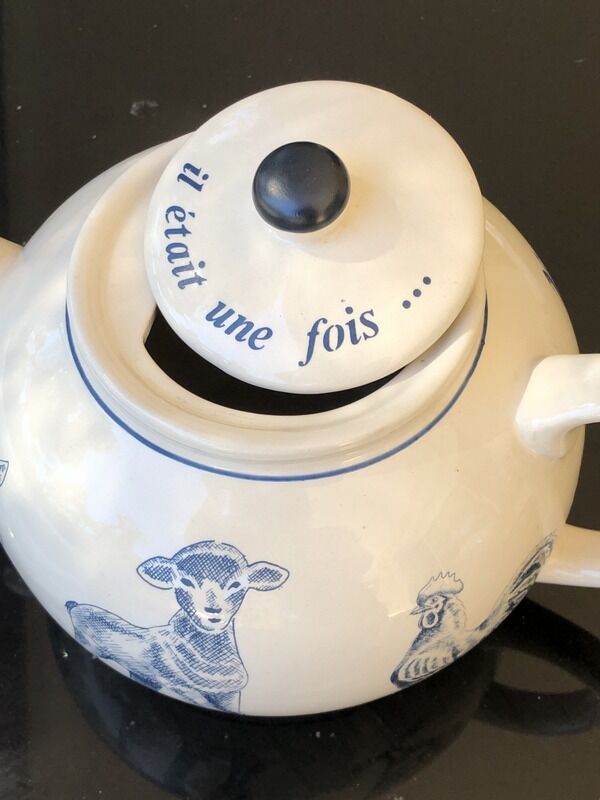 White porcelain teapot decorated with animals