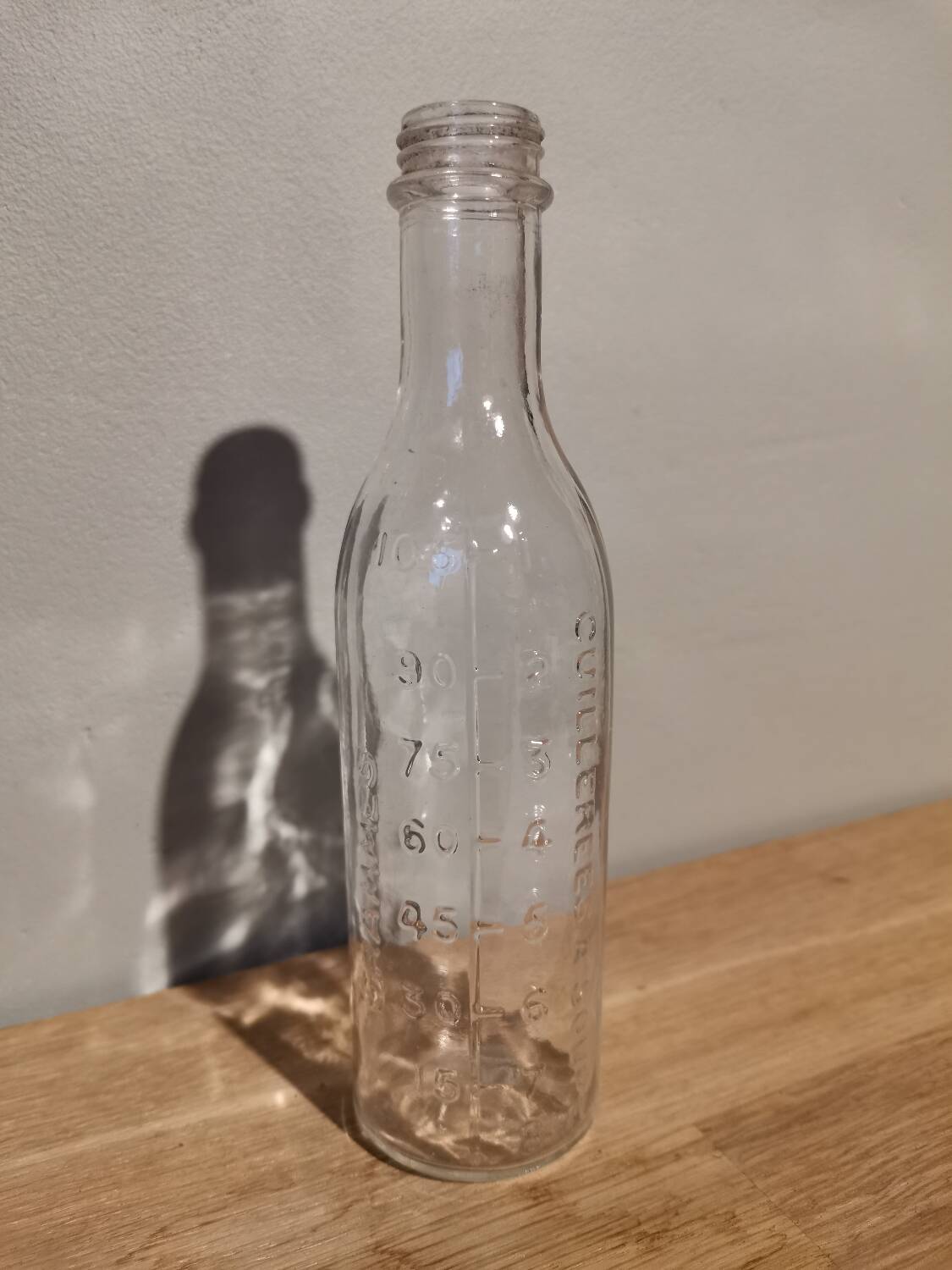 Vintage molded glass graduated apothecary pharmacy bottle