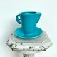 Milk jug on plate