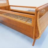 Vintage oak and rattan baby cot from the 1960s.