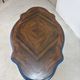 Wooden gueridon with a violin-shaped top in Rio rosewood, central base resting on four legs, reinterpreted in Baltic blue.