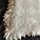 White cotton bedspread, crocheted sofa throw with star patterns