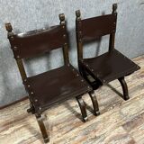 Pair of medieval style chairs in solid wood and leather, 19th century, circa 1850