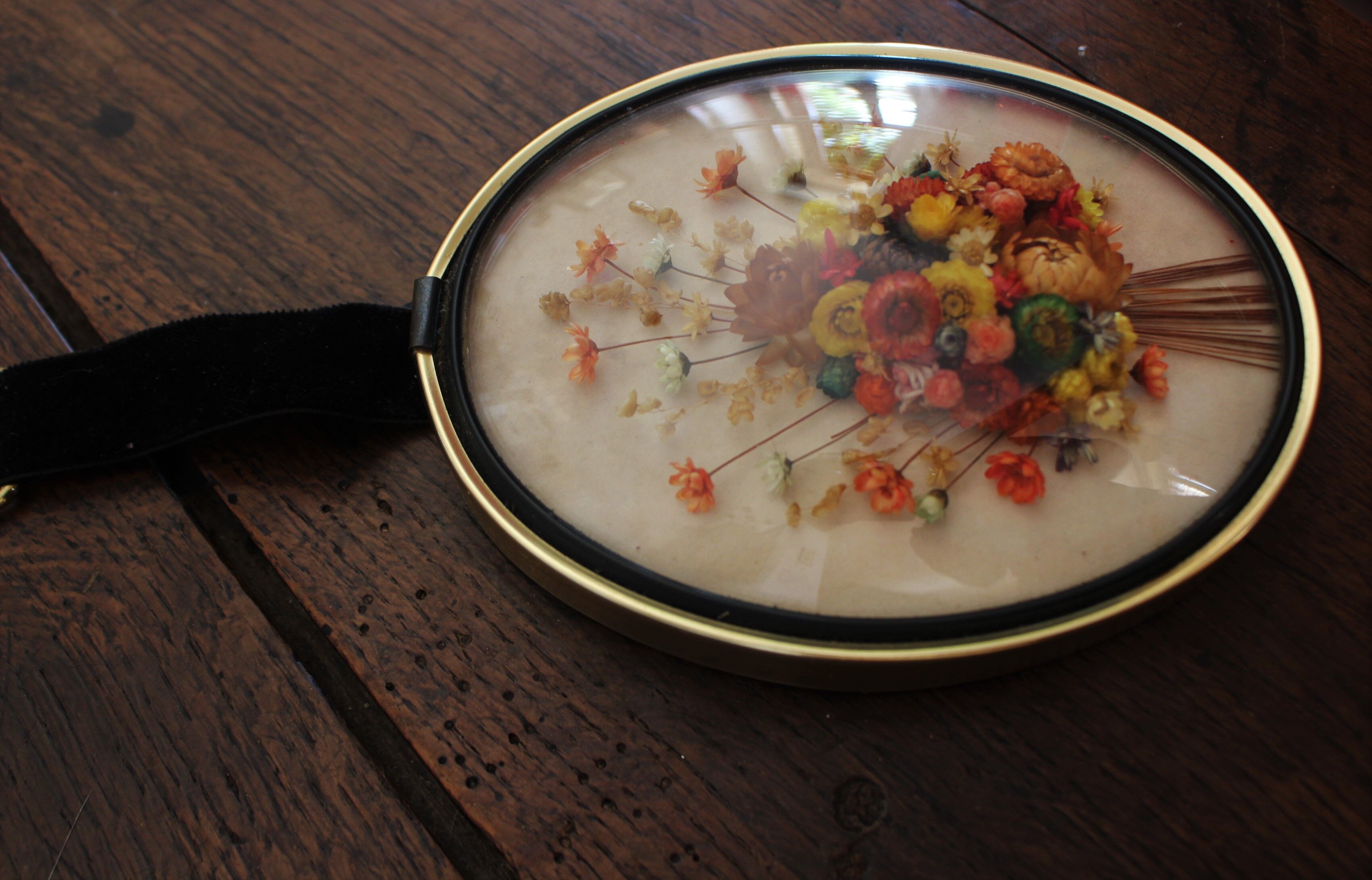 Vintage medallion domed glass dried flowers black gold