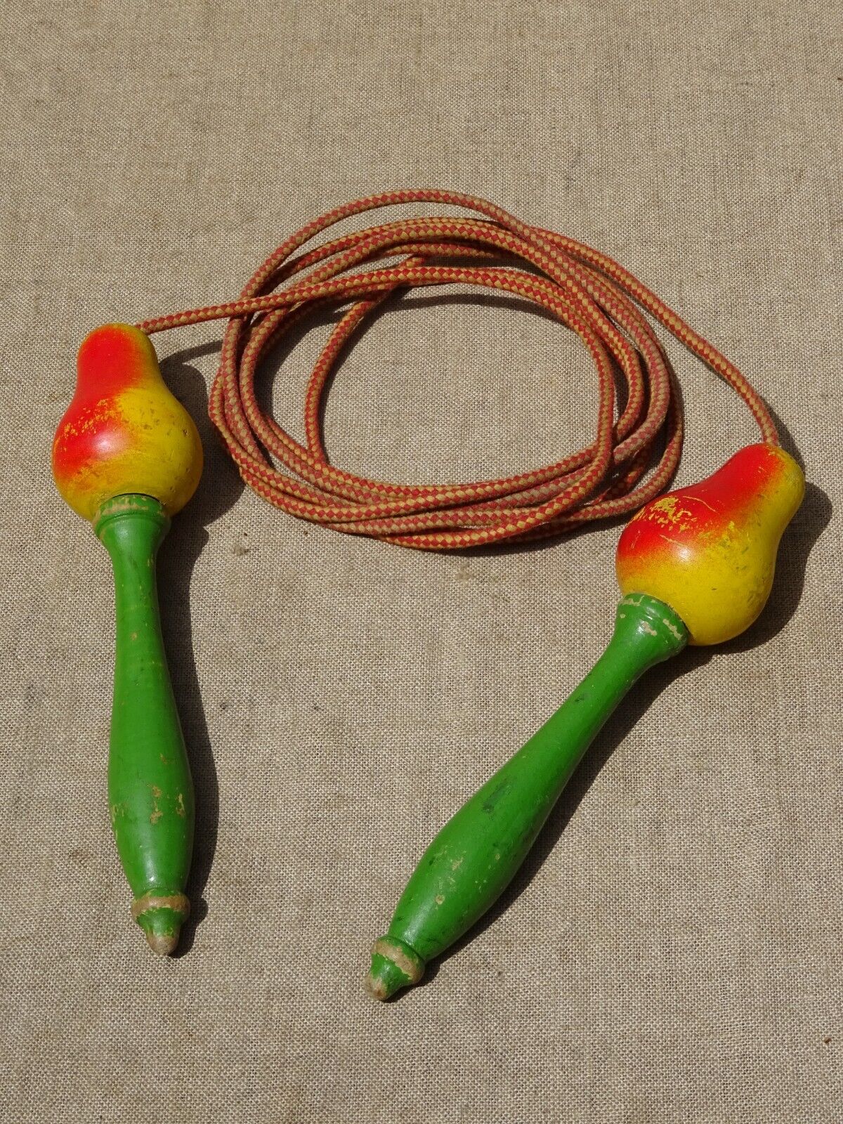 Old wooden jump rope toy painted in the shape of pear fruit ref
