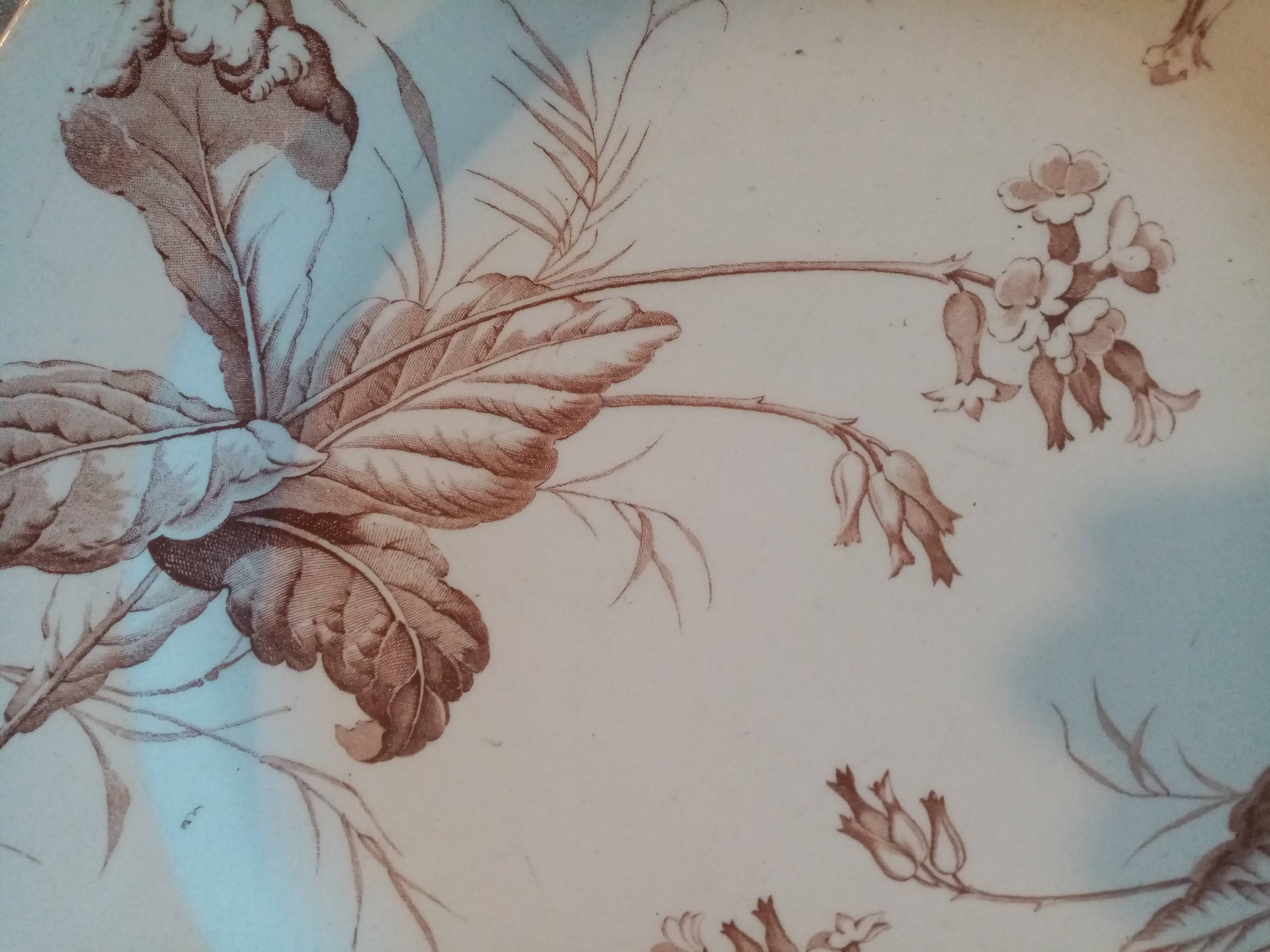 Old round earthenware dish from kg luneville with brown floral decoration