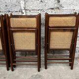 Serie de 8 chaises pliantes vintage en bois et cannage 1960