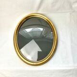 Old oval gilded wooden frame with domed glass