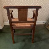 Antique armchair in carved wood with a straw seat.