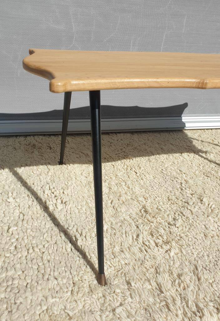 Violin-shaped coffee table with brass legs