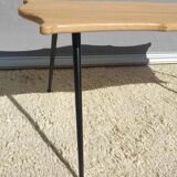 Violin-shaped coffee table with brass legs