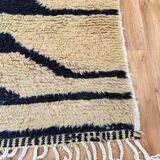 Handmade Moroccan rug in ecru with coloured patterns, 250cm x 150cm.