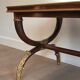 Coffee table in patinated and gilded carved wood with mirror top