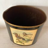 Metal wastebasket with bird decoration