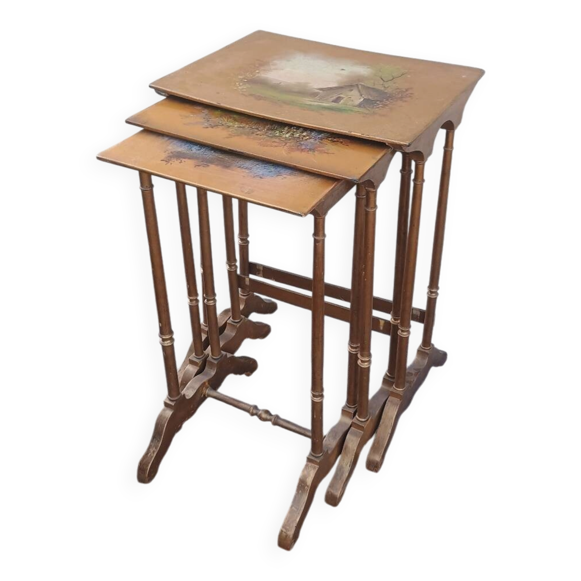 Sets of three nesting tables with painted landscape decorations in poplar.