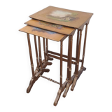 Sets of three nesting tables with painted landscape decorations in poplar.