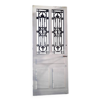 Antique oak entrance door with glass and cast iron grilles, 1925