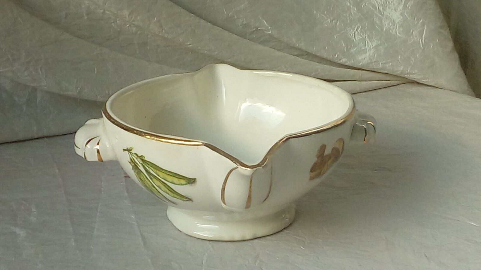 Sauceboat in earthenware decorated with four seasons vegetables.