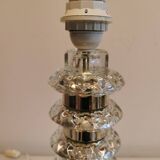 Table lamp made of transparent crystal glass and silver colored spacers.