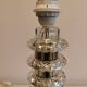 Table lamp made of transparent crystal glass and silver colored spacers.