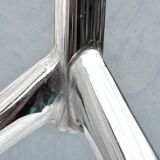 Modernist tripod side table in tempered glass and chrome metal.