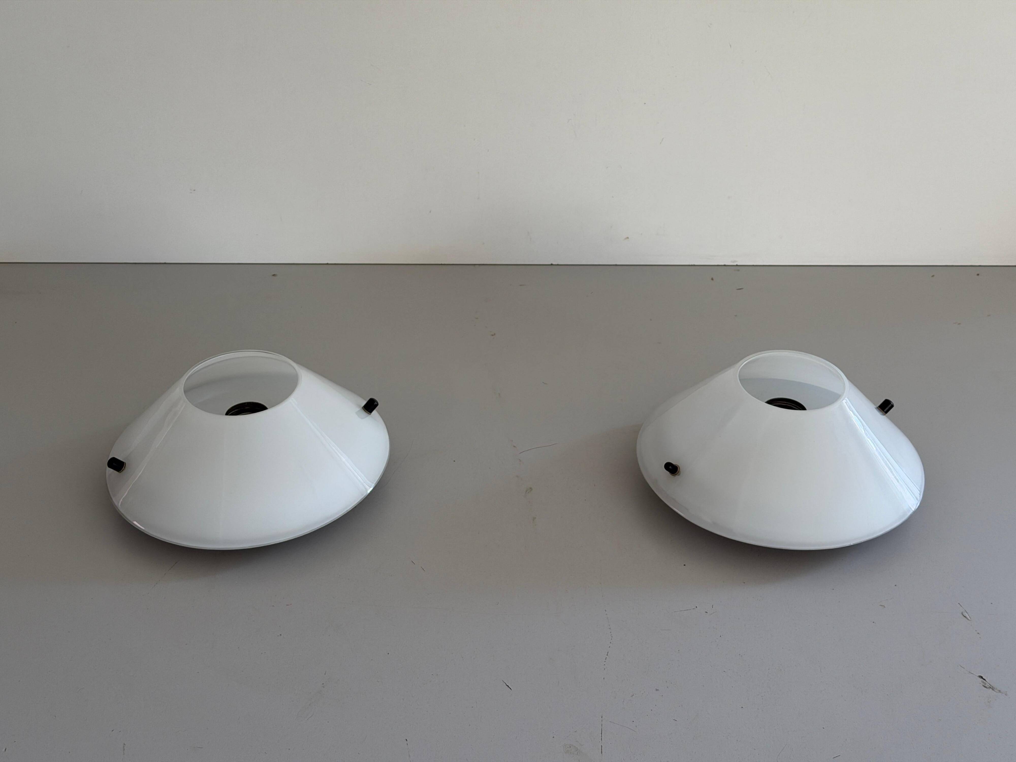 Pair of opal glass wall lights from the mid-century by Lamperti, 1960s, Italy.