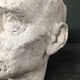 Head of a man with a plaster mustache