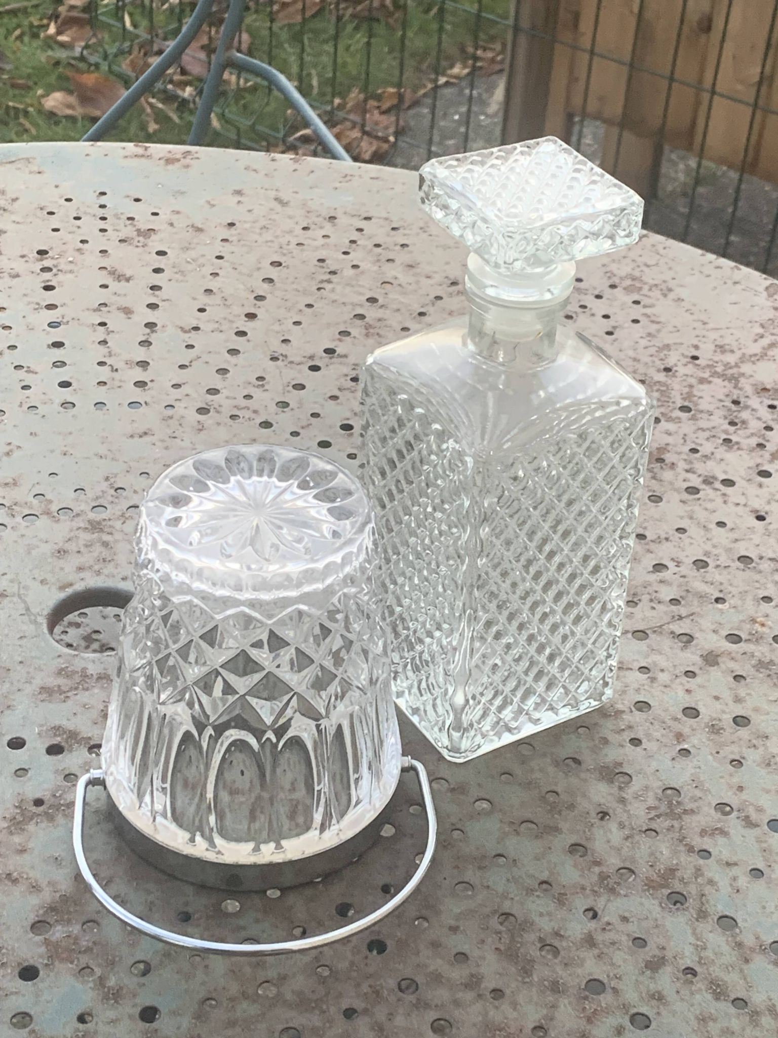 Whiskey carafe and ice bucket in transparent glass and silver-colored metal handle