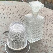 Whiskey carafe and ice bucket in transparent glass and silver-colored metal handle