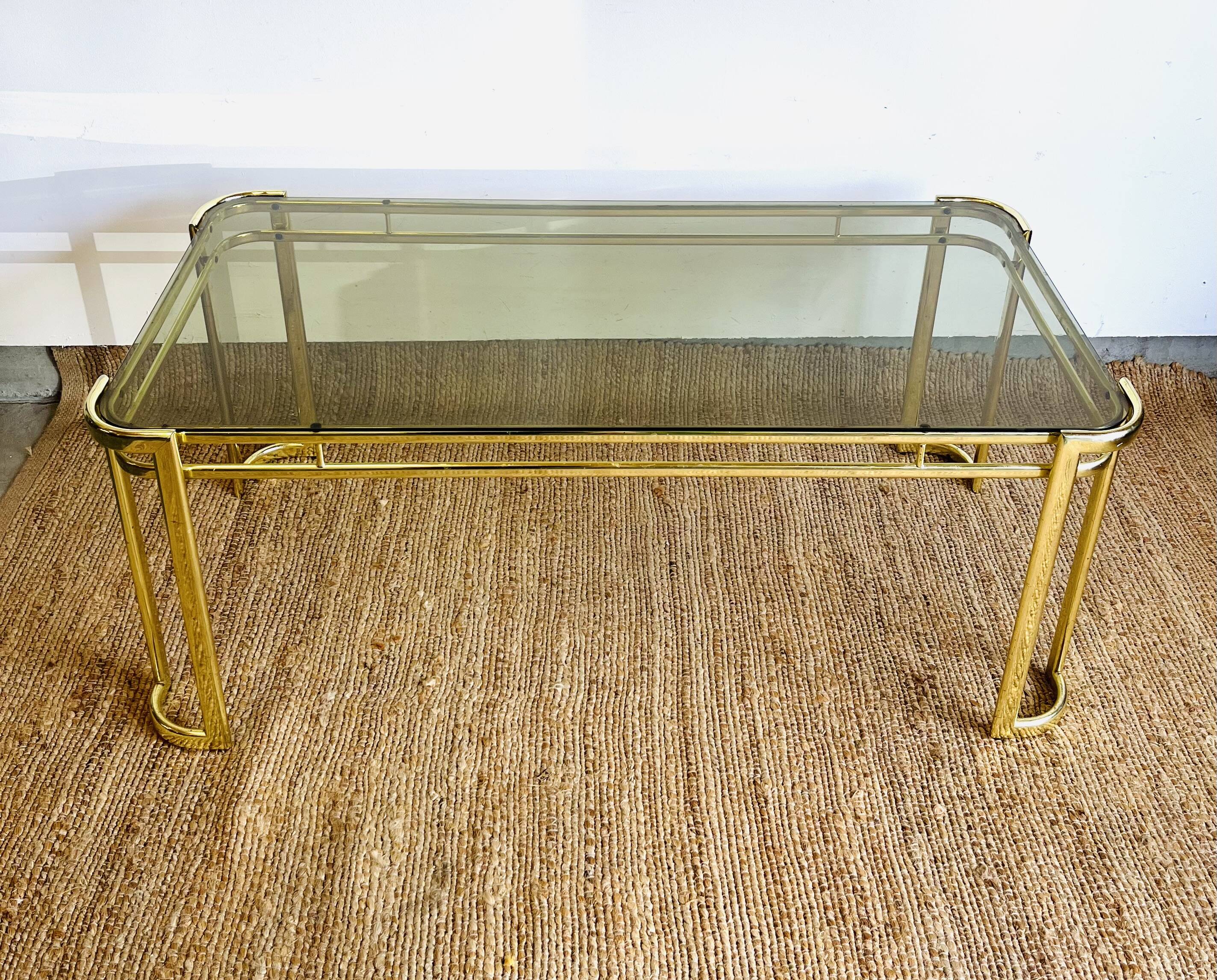 Gold metal and smoked glass coffee table – 1970s-624001