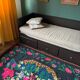 Romanian black wool carpet with a basket of colorful flowers