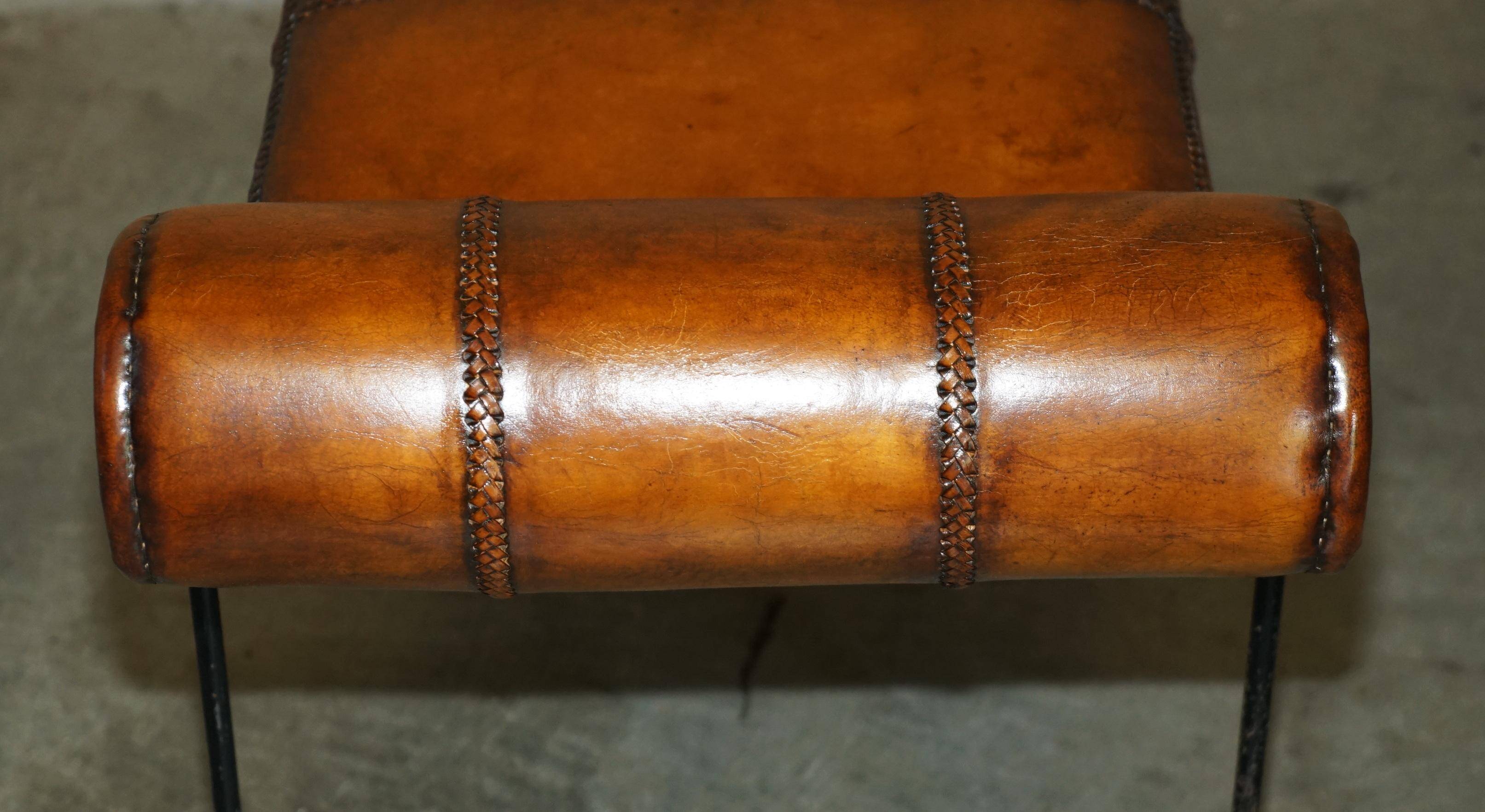 Vintage Spanish window bench in hand-stitched leather and restored iron.