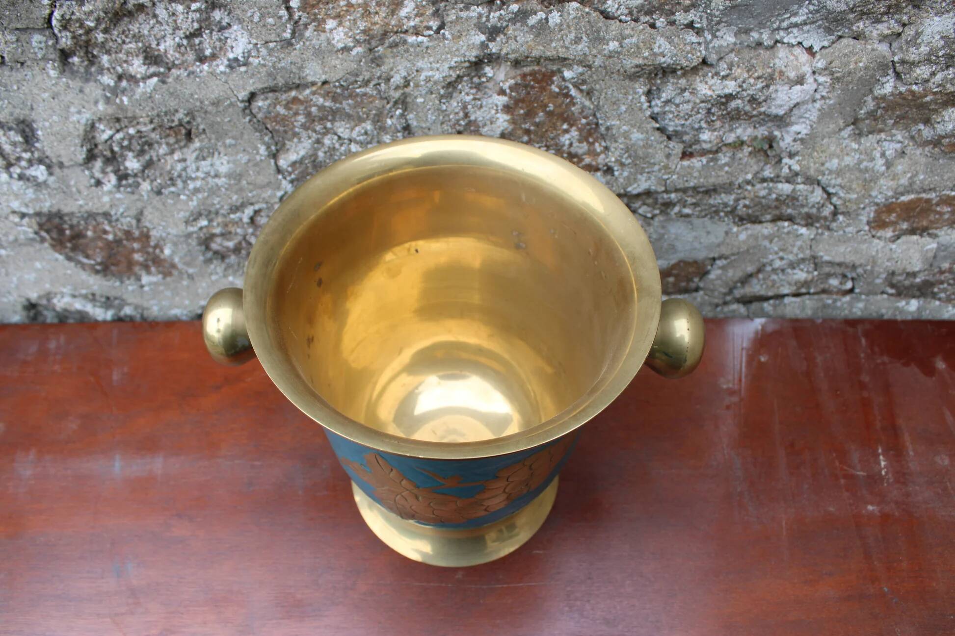 Vintage turquoise brass champagne bucket with grape decoration.