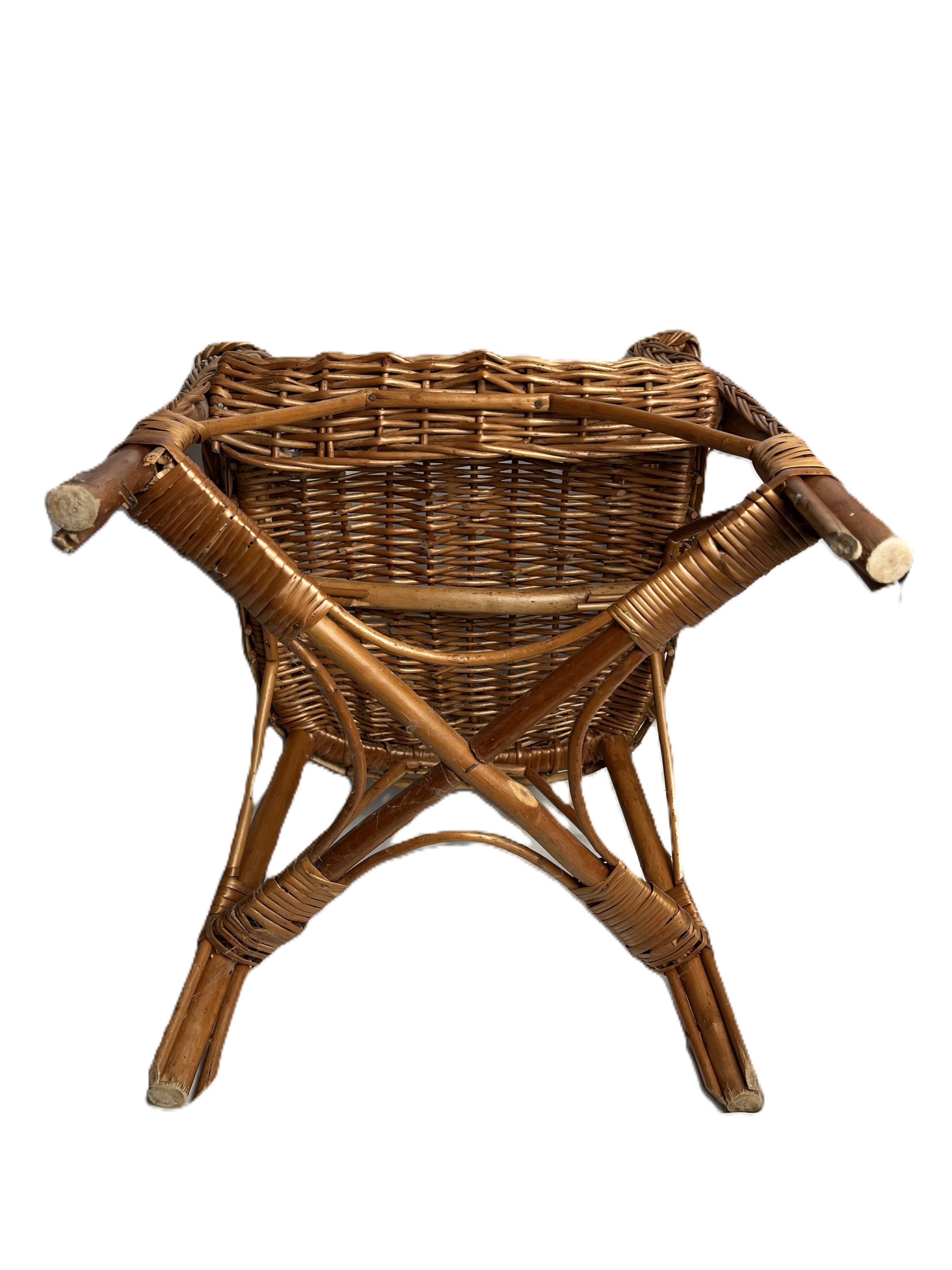 Vintage, children's armchair in woven rattan from around 1970.
