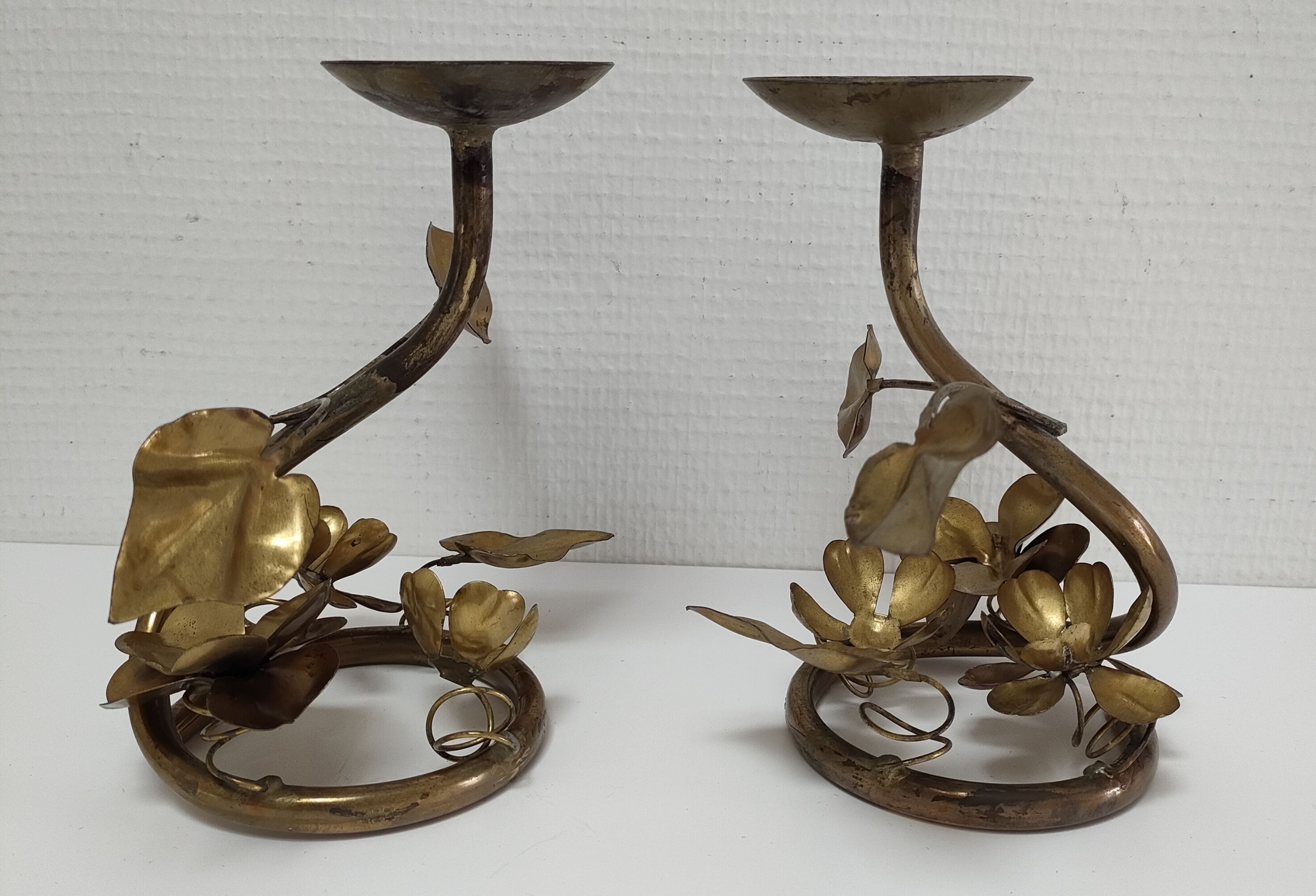 Pair of brass candle holders decorated with patinated metal flowers