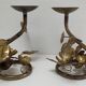 Pair of brass candle holders decorated with patinated metal flowers