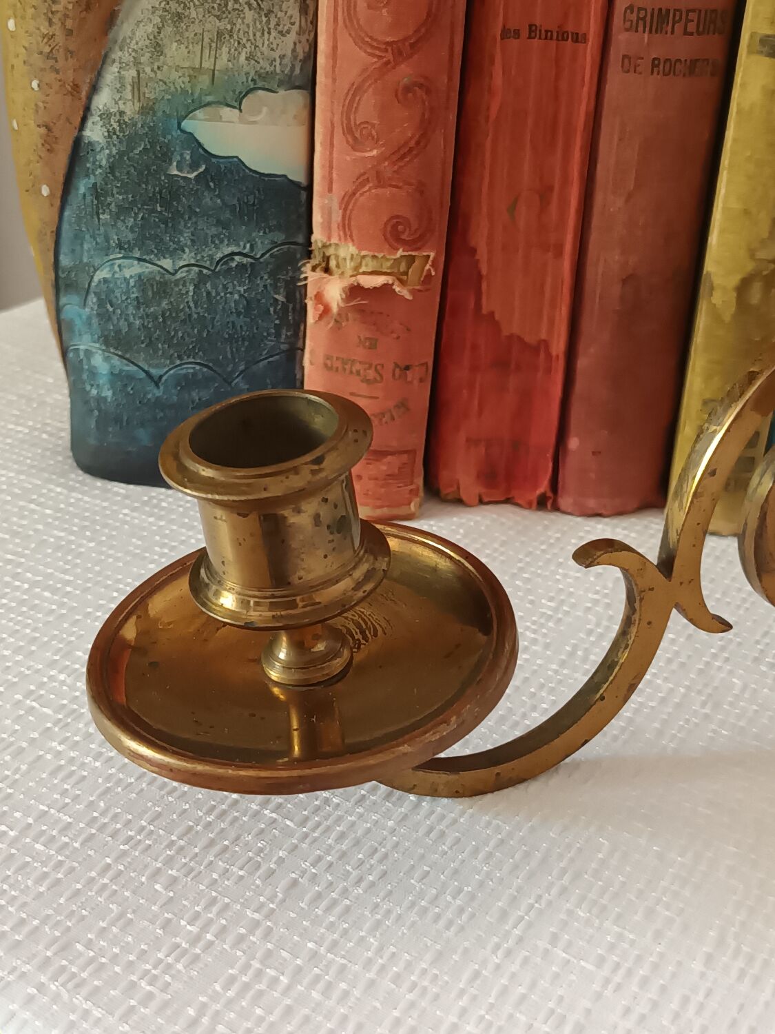 Pair of antique wall-mounted brass candle holders