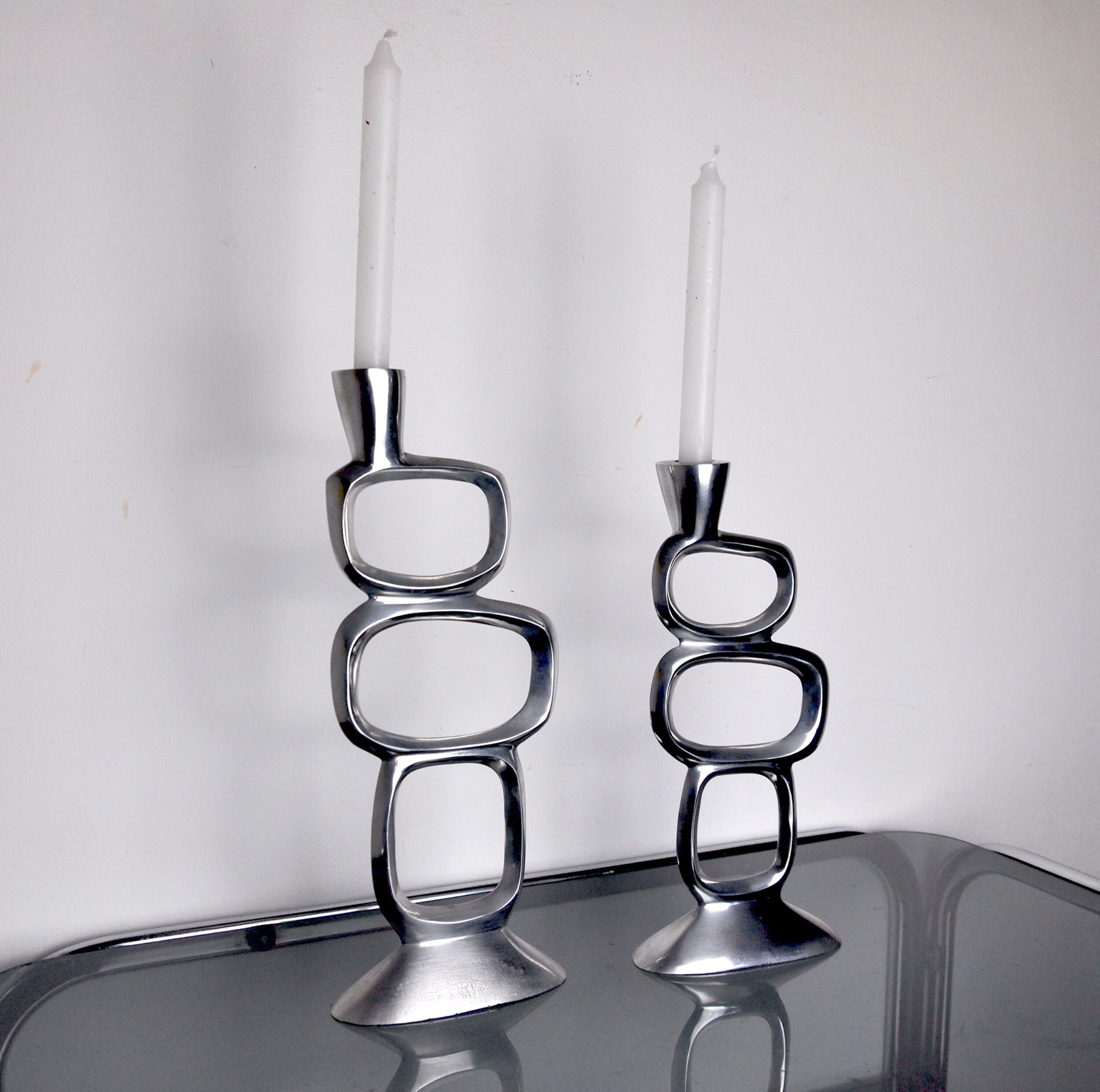 Pair of circle candlesticks by matthew hilton, england, 1980