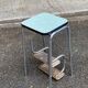 Folding stool in chrome steel, blue formica and solid wood.