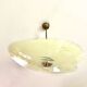 Pale yellow asymmetrical suspension cup 1960